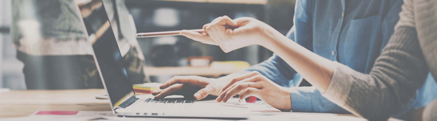 two people working on laptop banner