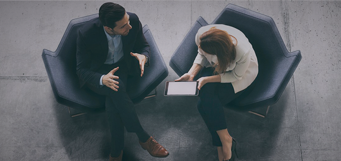 man and woman formally dressed having a conversation mobile banner